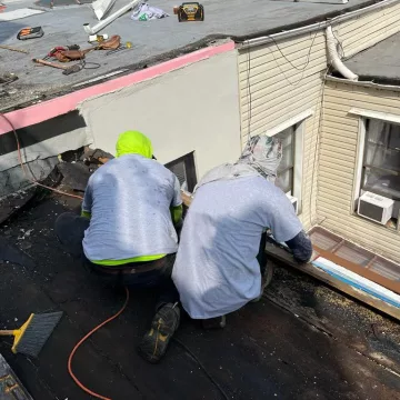 michael starting a work on the damaged roofing of the customer